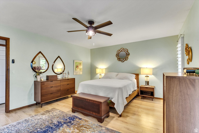 2863 Fallentine Road Sandy, UT 84093 - Photo 29 of 48 Spacious bedroom featuring light wood-finish flooring, a ceiling fan with integrated lighting, and a white plantation shuttered window