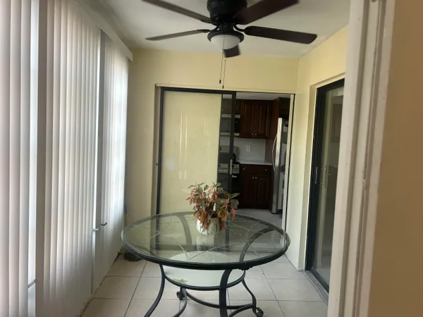 a dining room with furniture and a chandelier