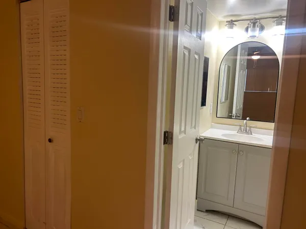 a bathroom with a double vanity and a mirror
