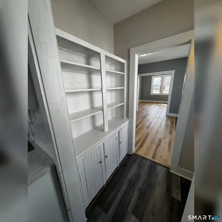 a view of a room with wooden floor and closet
