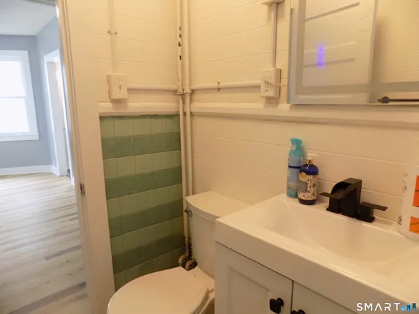 a view of an empty room with cabinet and a window