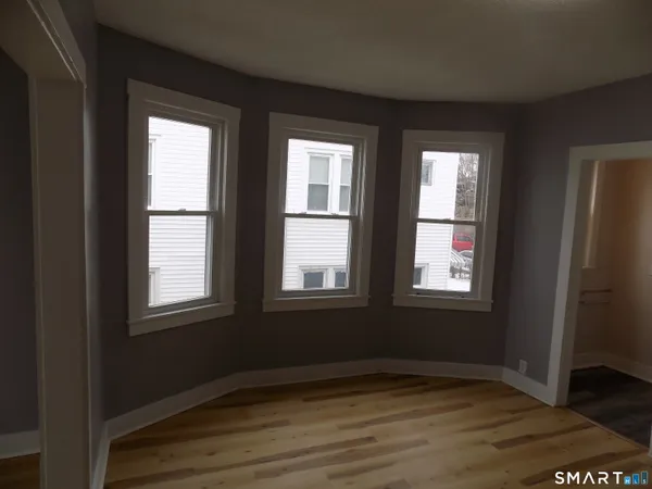 a view of a room with wooden floor and closet