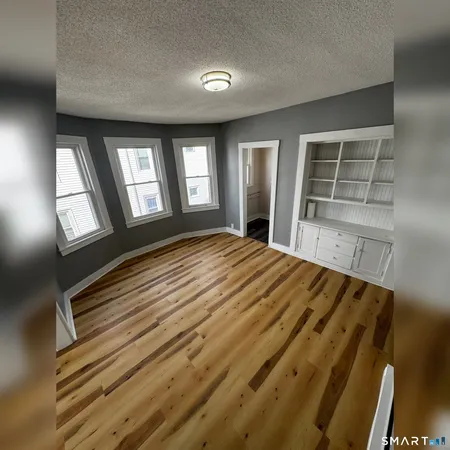a view of wooden floor and windows in a room