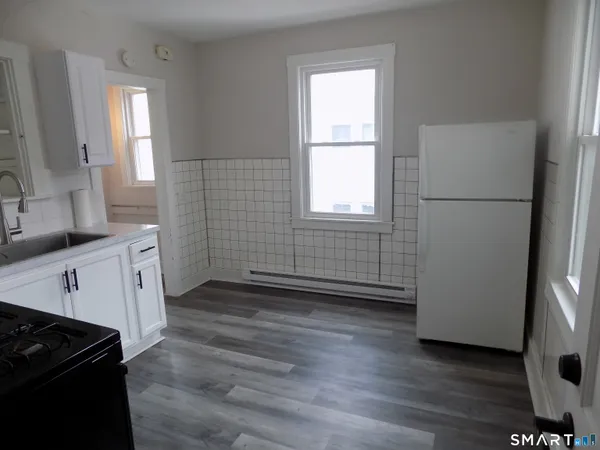 a kitchen with stainless steel appliances a white stove top oven and a refrigerator