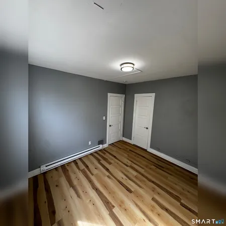 a bedroom with a bed and a mirror