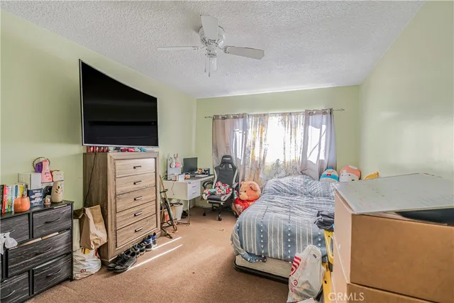 a bedroom with furniture and a flat screen tv