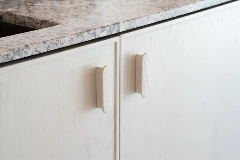 a bed room with furniture a potted plant and a kitchen view