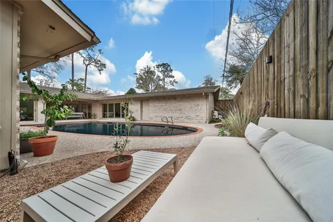 a view of a patio with a table and chairs