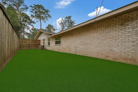 a backyard of a house with table and chairs