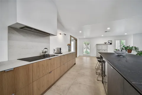 a kitchen with stainless steel appliances a sink stove and cabinets