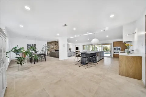 a living room with furniture and a table with potted plants