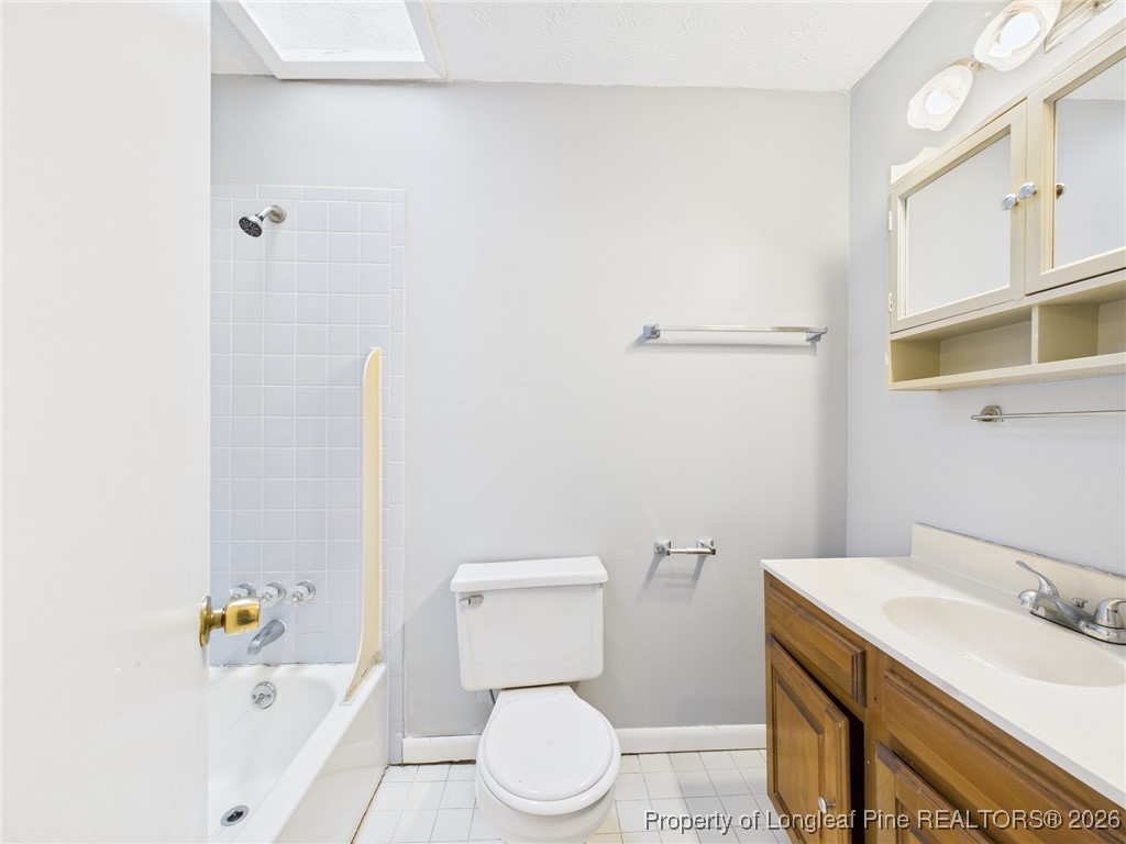1540 Mack Street Spring Lake, NC 28390 - Photo 15 of 31 a bathroom with a sink a toilet and a bathtub