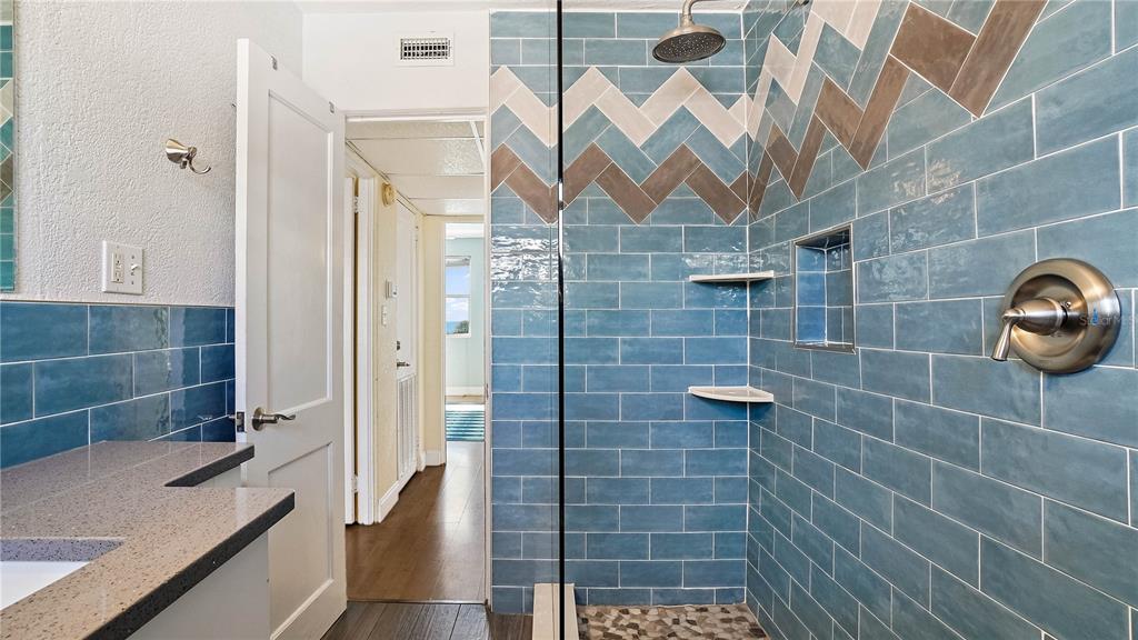 6700 Sunset Way, Unit 206 St. Pete Beach, FL 33706 - Photo 12 of 24 a bathroom with a shower