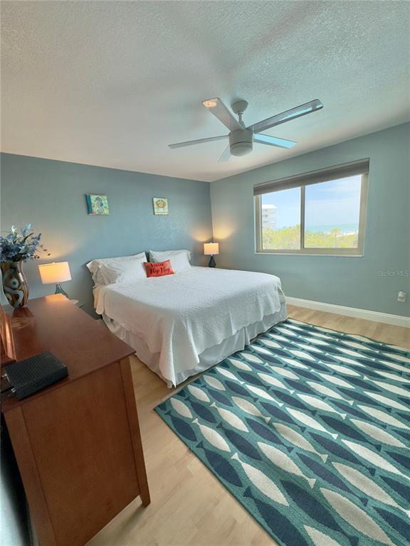 6700 Sunset Way, Unit 206 St. Pete Beach, FL 33706 - Photo 16 of 24 a bedroom with two beds and a dresser