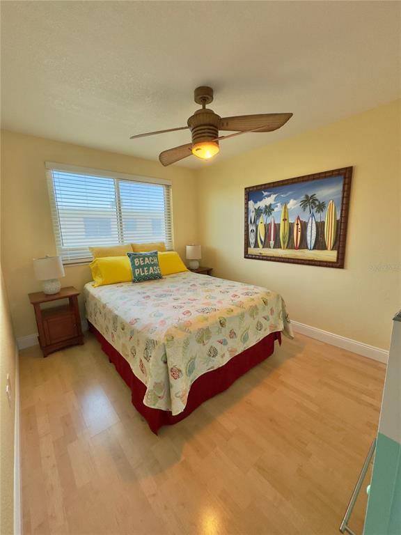 6700 Sunset Way, Unit 206 St. Pete Beach, FL 33706 - Photo 23 of 24 a bedroom with a bed and a painting on the wall