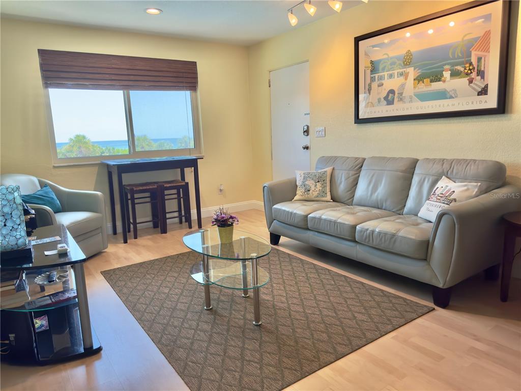 6700 Sunset Way, Unit 206 St. Pete Beach, FL 33706 - Photo 9 of 24 a living room with furniture and a fireplace