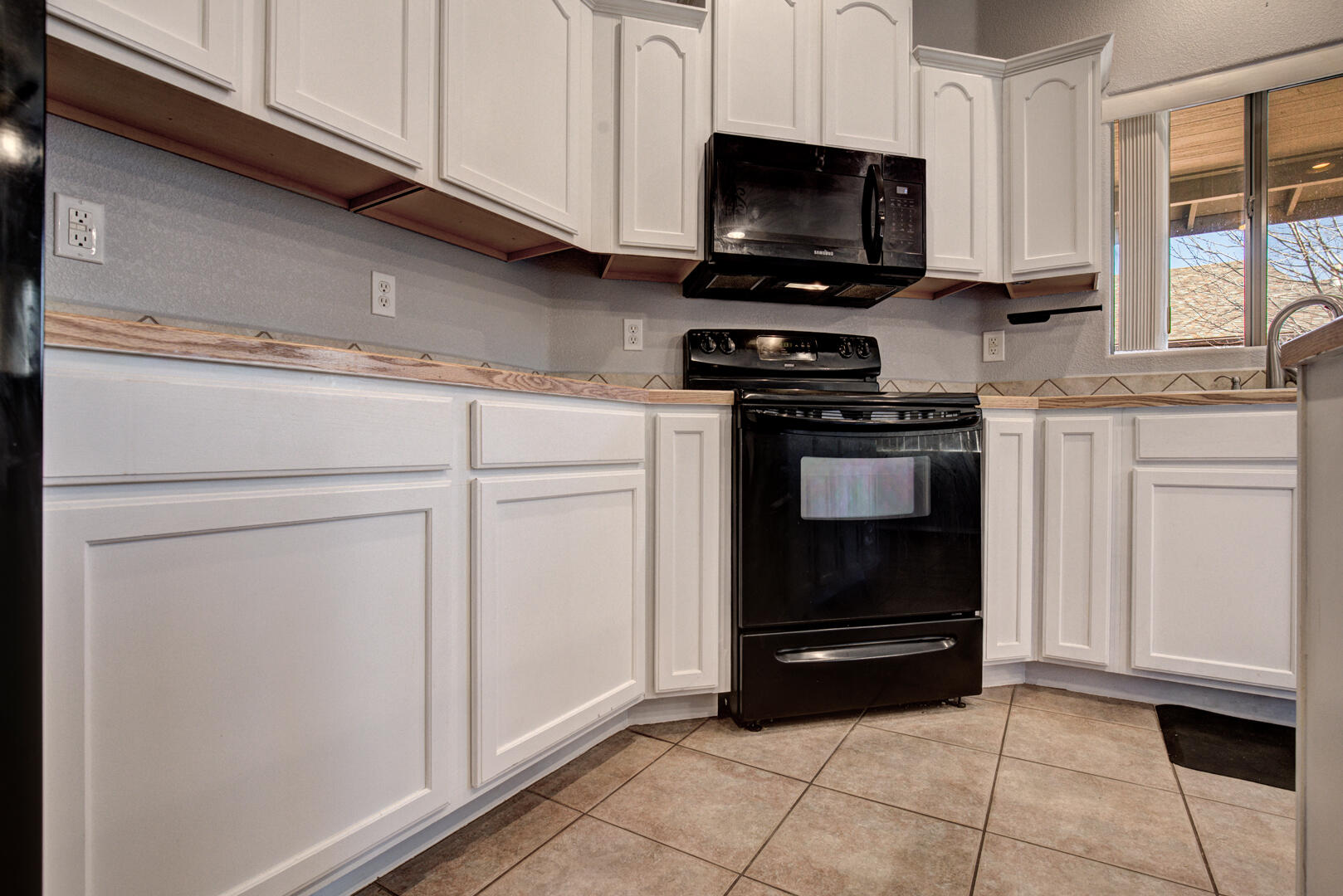 334 East Cedar Mill Road Star Valley, AZ 85541 - Photo 10 of 32 a kitchen with white cabinets and appliances