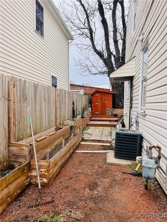1703 Decatur Street Richmond, VA 23224 - Photo 23 of 24 View of yard with a vegetable garden, a storage un