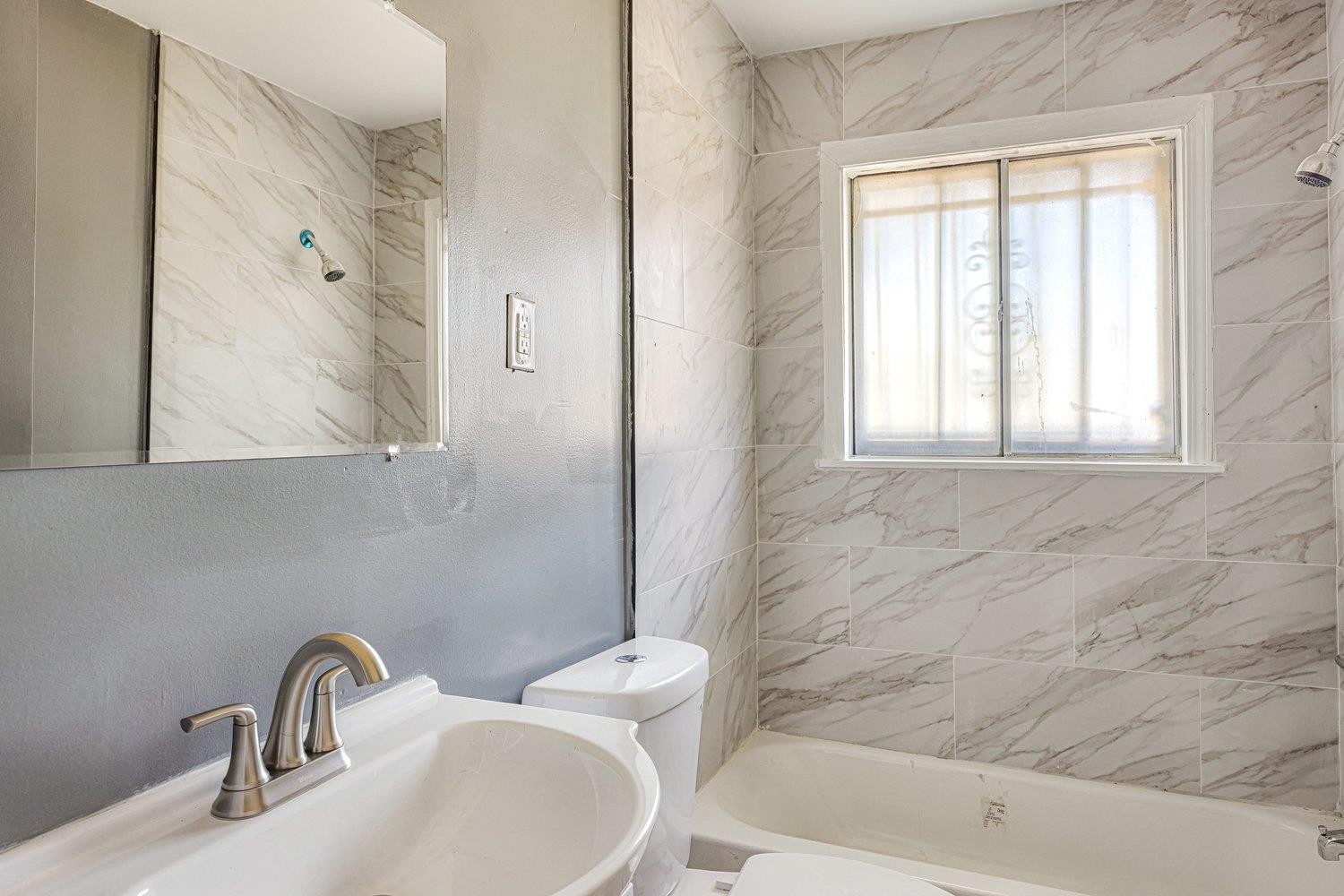 4025 Bishops Bridge Road Memphis, TN 38118 - Photo 16 of 18 a bathroom with a sink and a bathtub