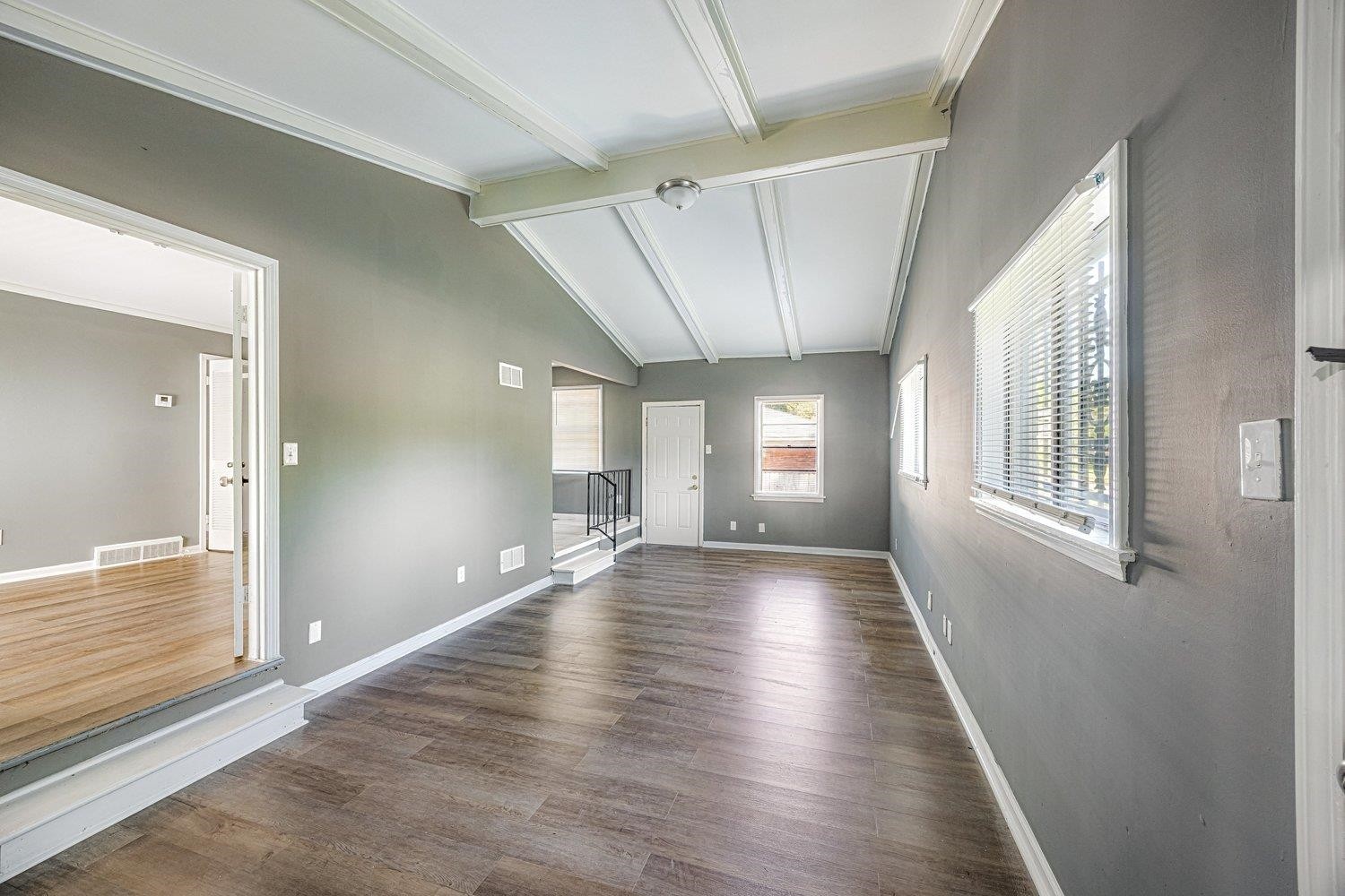 4025 Bishops Bridge Road Memphis, TN 38118 - Photo 5 of 18 a view of an empty room with wooden floor and a window