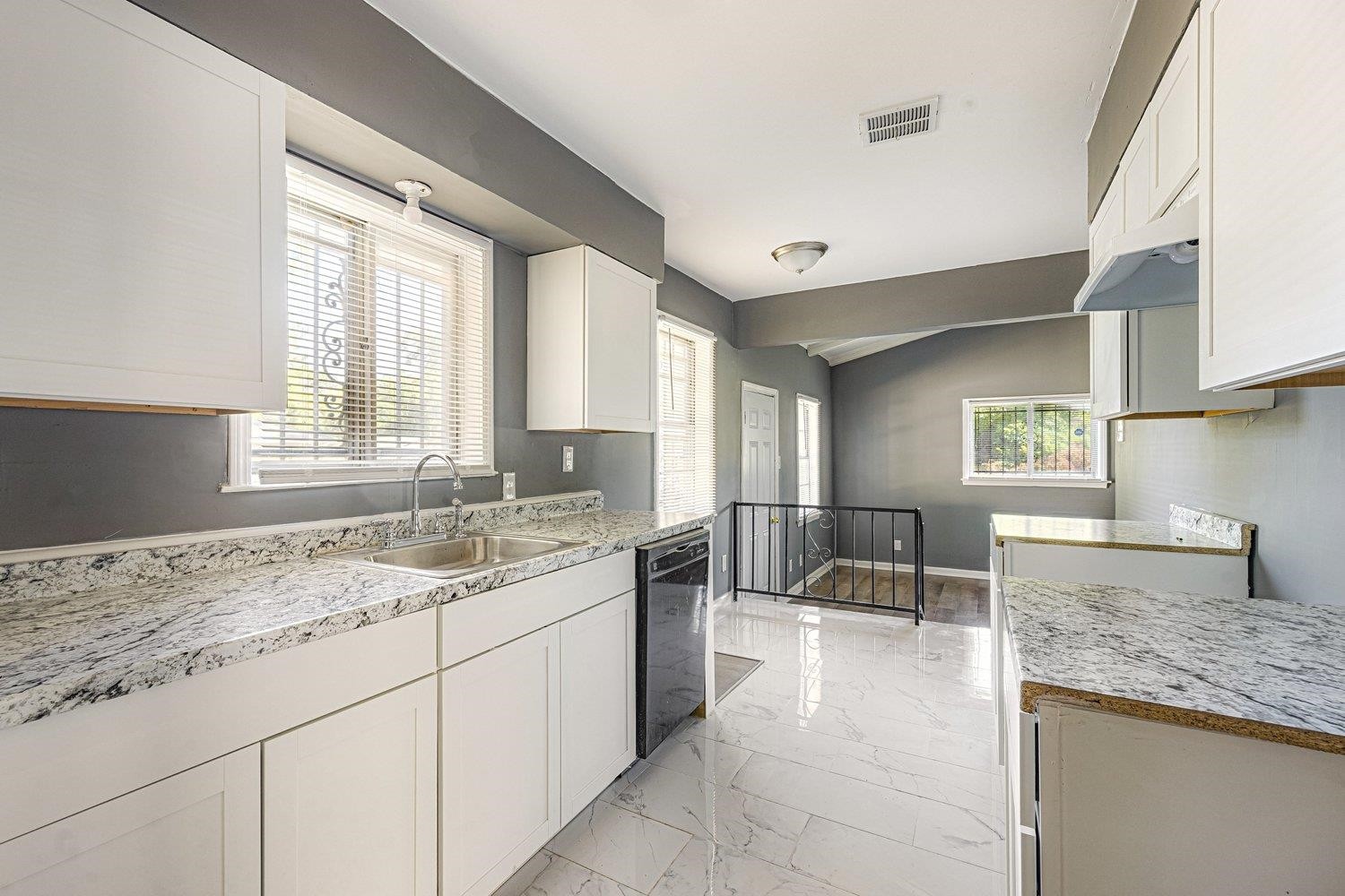 4025 Bishops Bridge Road Memphis, TN 38118 - Photo 8 of 18 a kitchen with granite countertop a sink and white cabinets