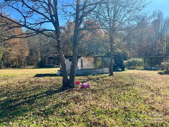 a view of a yard with swimming pool and sitting area