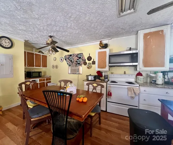 a kitchen with stainless steel appliances granite countertop a stove a sink dishwasher and a refrigerator with wooden cabinets