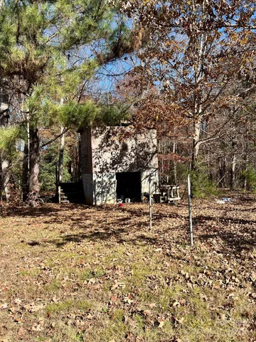 a view of a backyard with large trees