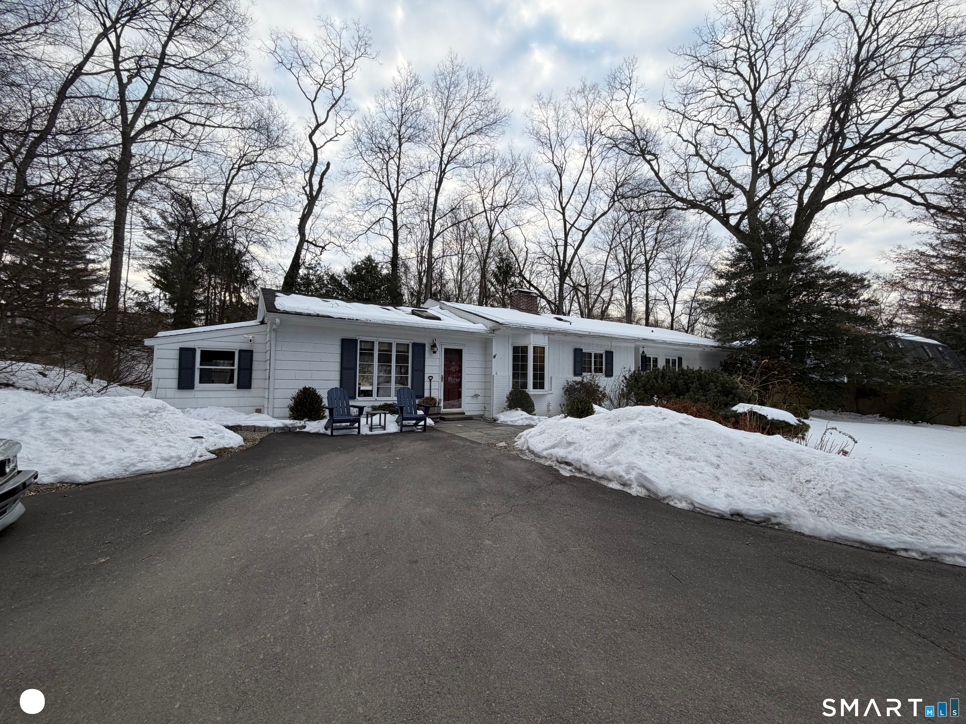20 Arrowhead Road Wilton, CT 06897 - Photo 1 of 28 a front view of a house with a yard and garage