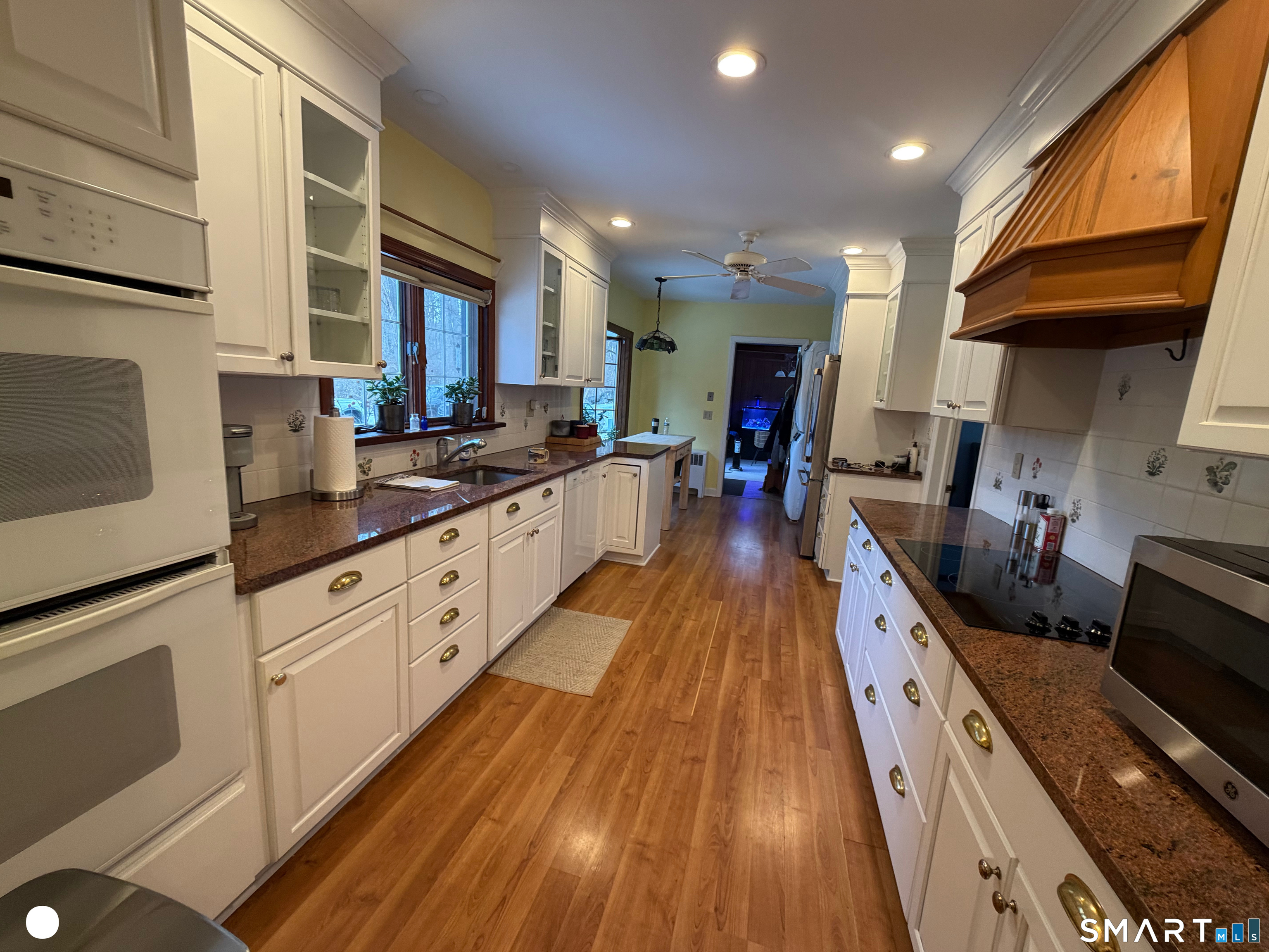 20 Arrowhead Road Wilton, CT 06897 - Photo 13 of 28 a large kitchen with stainless steel appliances lots of counter space and wooden floor