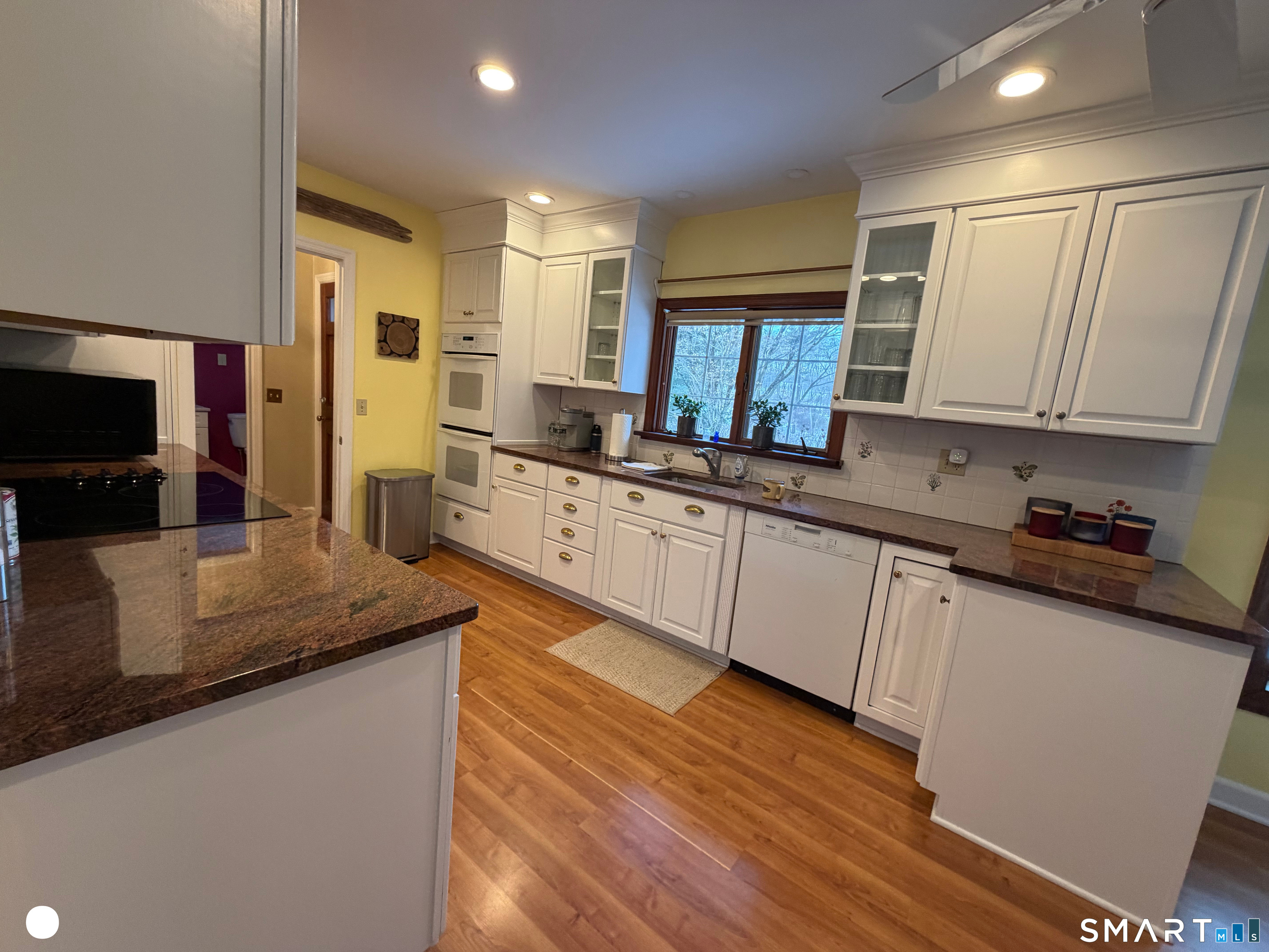 20 Arrowhead Road Wilton, CT 06897 - Photo 14 of 28 a kitchen with stainless steel appliances granite countertop a sink a stove counter space and cabinets