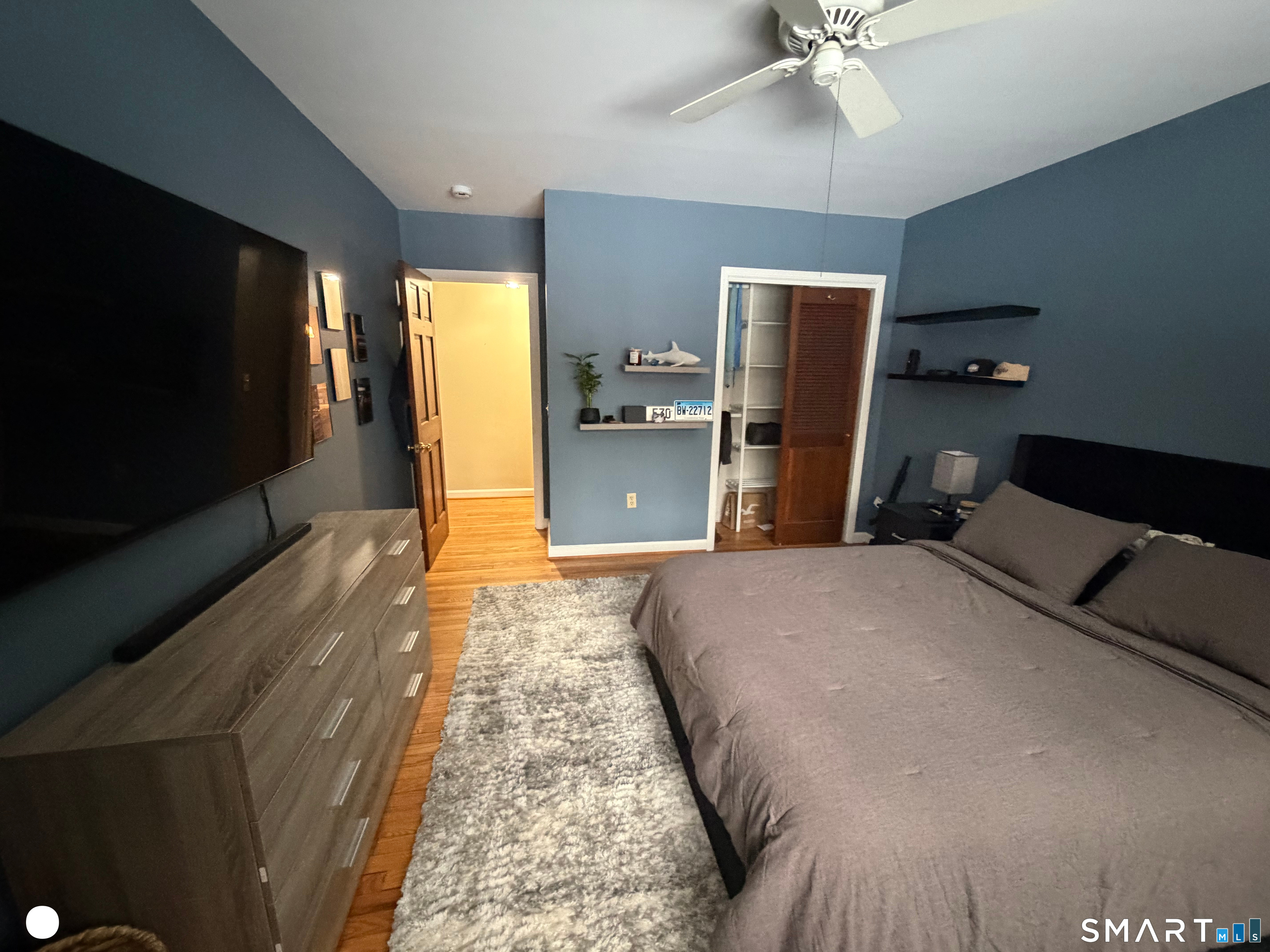 20 Arrowhead Road Wilton, CT 06897 - Photo 18 of 28 a bedroom with a bed and a flat tv screen on dresser