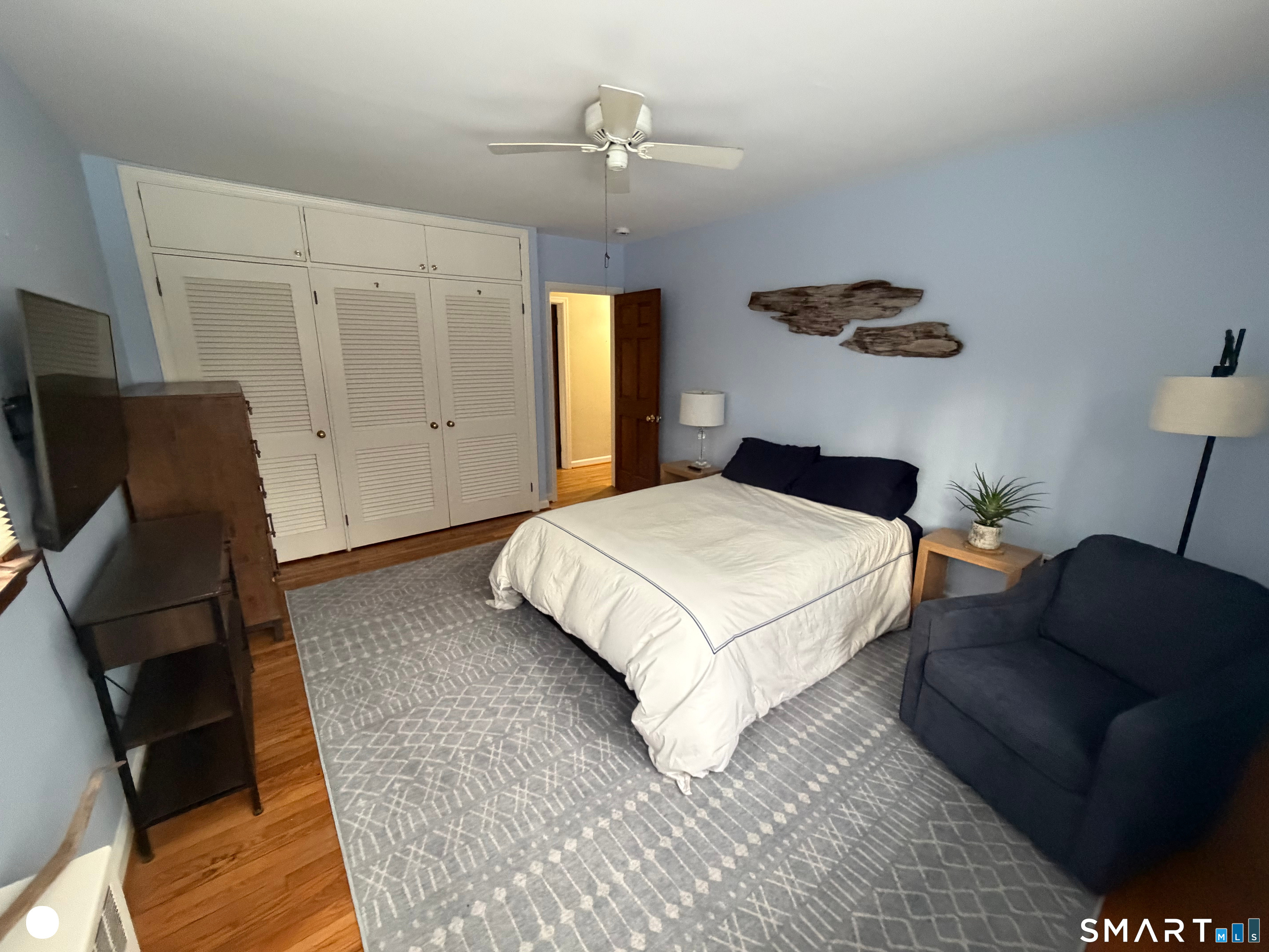 20 Arrowhead Road Wilton, CT 06897 - Photo 19 of 28 a bedroom with a bed mirror and couch