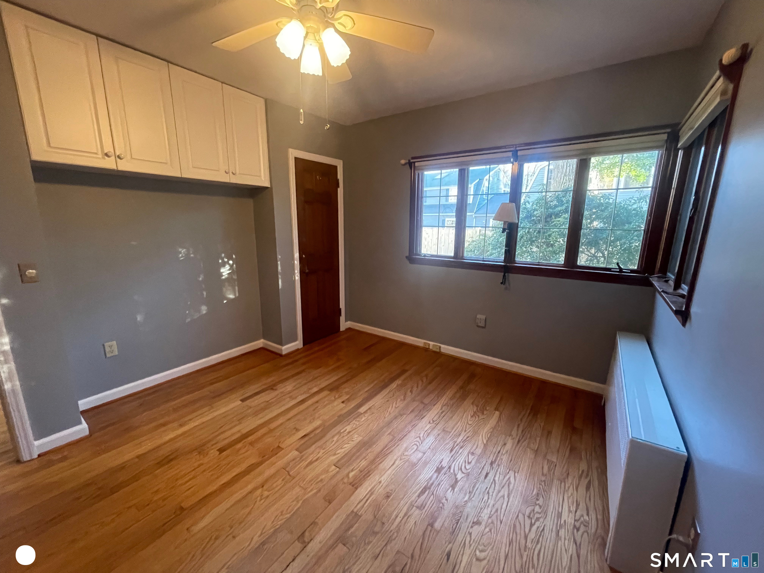 20 Arrowhead Road Wilton, CT 06897 - Photo 20 of 28 an empty room with wooden floor and windows