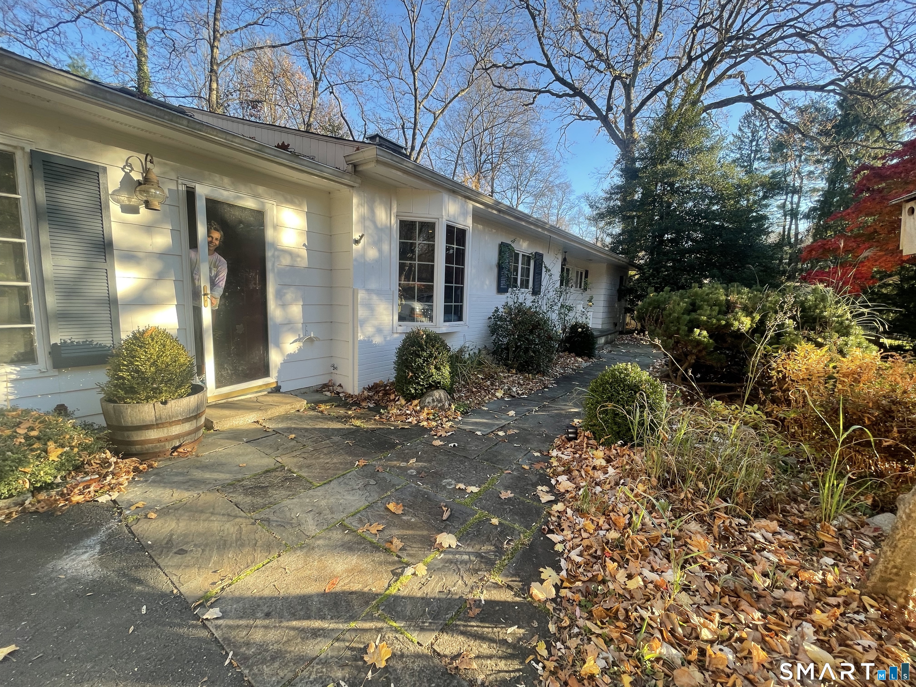 20 Arrowhead Road Wilton, CT 06897 - Photo 2 of 28 a view of a house with a small yard and plants