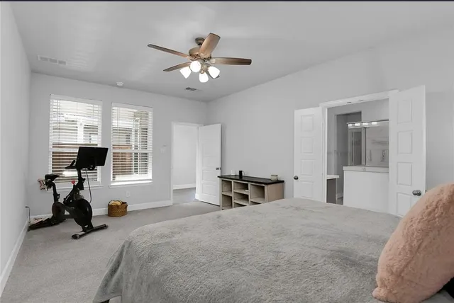 a bedroom with a bed and a desk