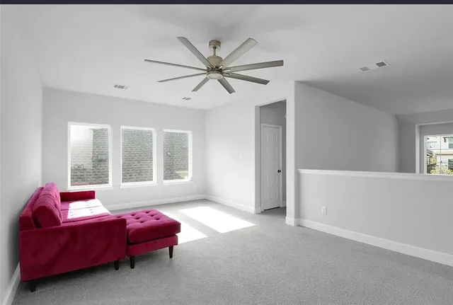 a living room with furniture and windows