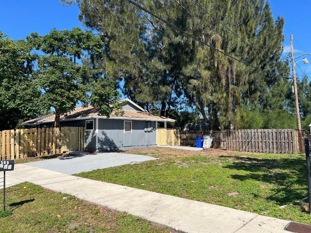 500 Northeast 34th Street Pompano Beach, FL 33064 - Photo 6 of 29 a front view of a house with a yard