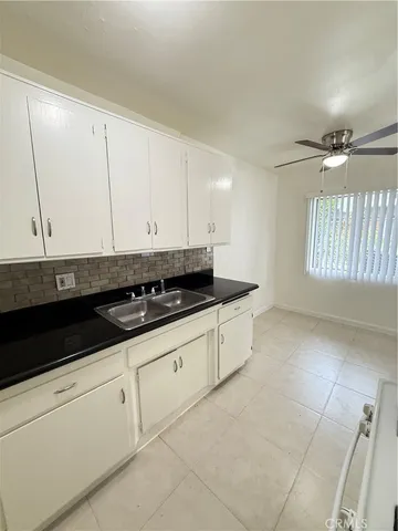a kitchen with stainless steel appliances white cabinets and sink