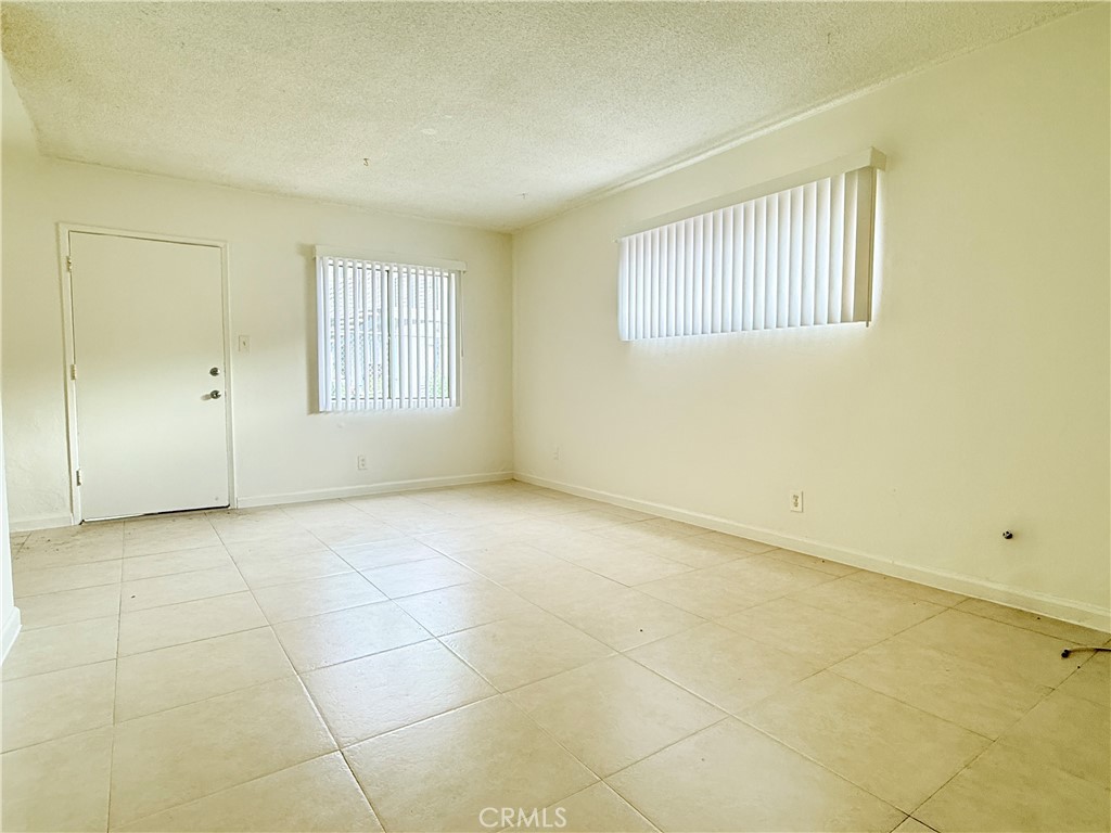 1168 North Mayfair Avenue, Unit 3 Anaheim, CA 92801 - Photo 4 of 10 a view of an empty room with a window