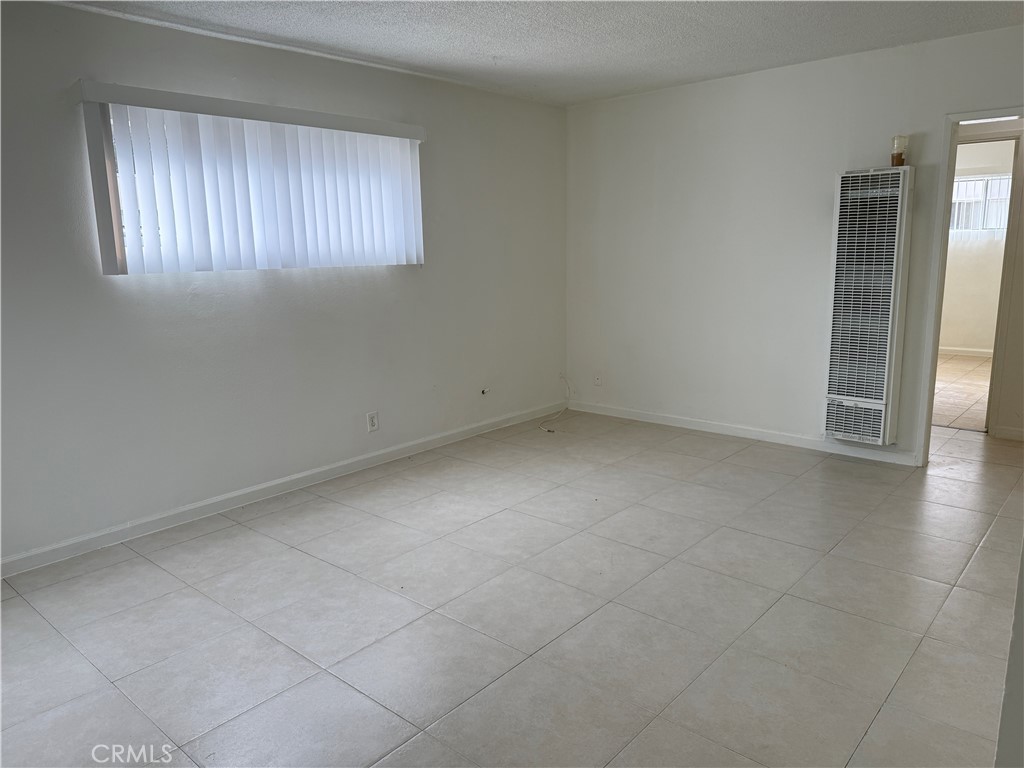 1168 North Mayfair Avenue, Unit 3 Anaheim, CA 92801 - Photo 5 of 10 an empty room with windows