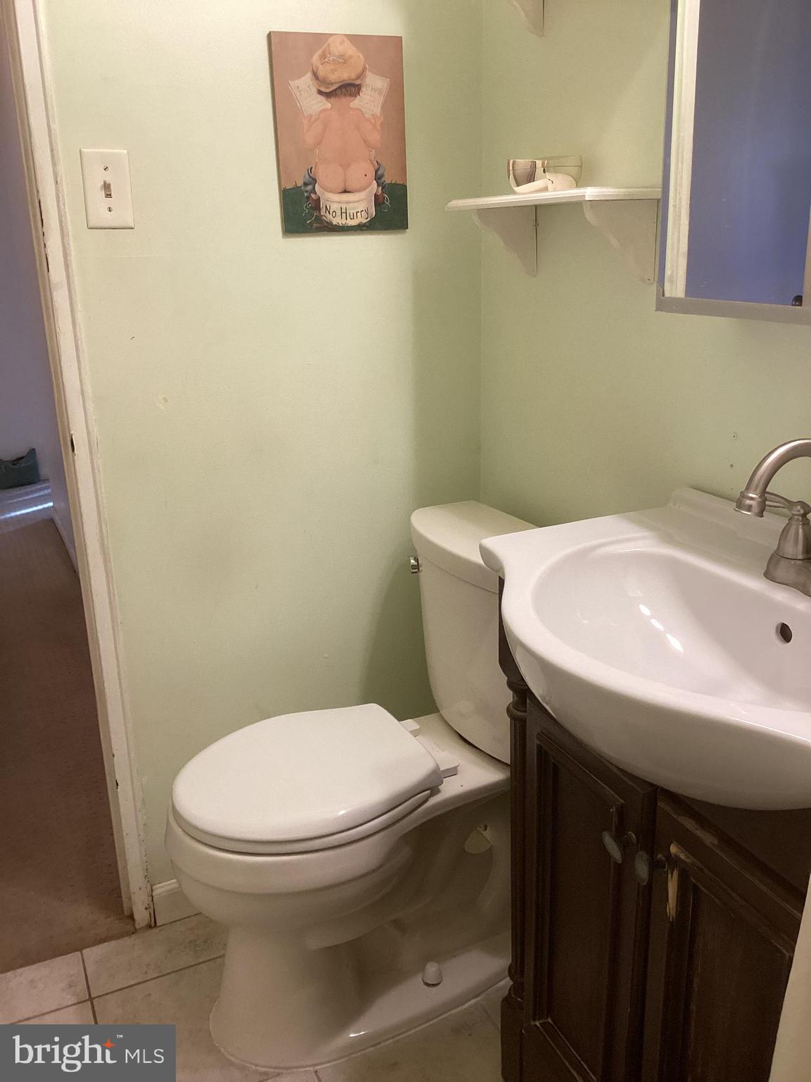 606 Fairhill Road Morrisville, PA 19067 - Photo 12 of 36 a white toilet sitting next to a bathroom sink