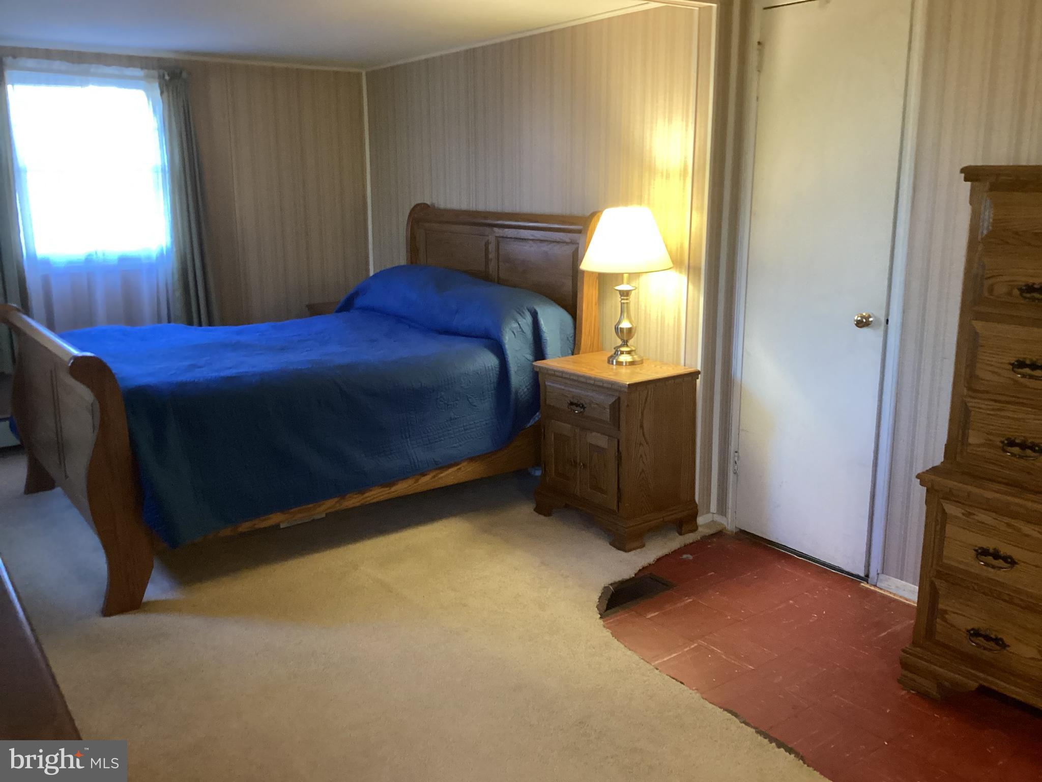 606 Fairhill Road Morrisville, PA 19067 - Photo 17 of 36 a bed sitting in a bedroom next to a window