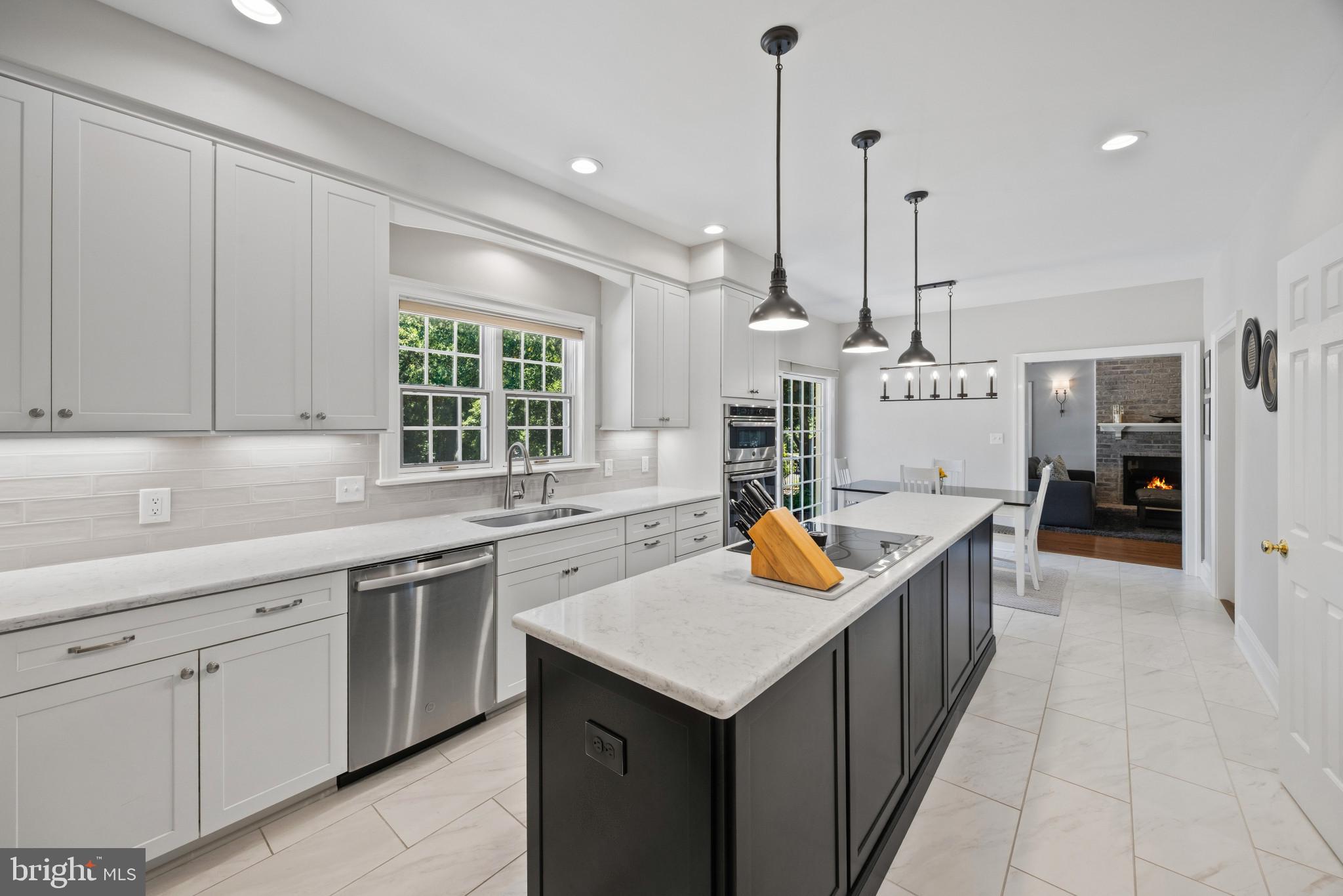 3403 Hidden River View Road Annapolis, MD 21403 - Photo 11 of 50 a kitchen with stainless steel appliances granite countertop a sink a stove and a wooden floors