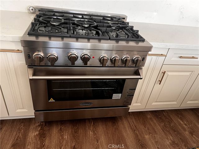 a room with a table chairs and wooden floor