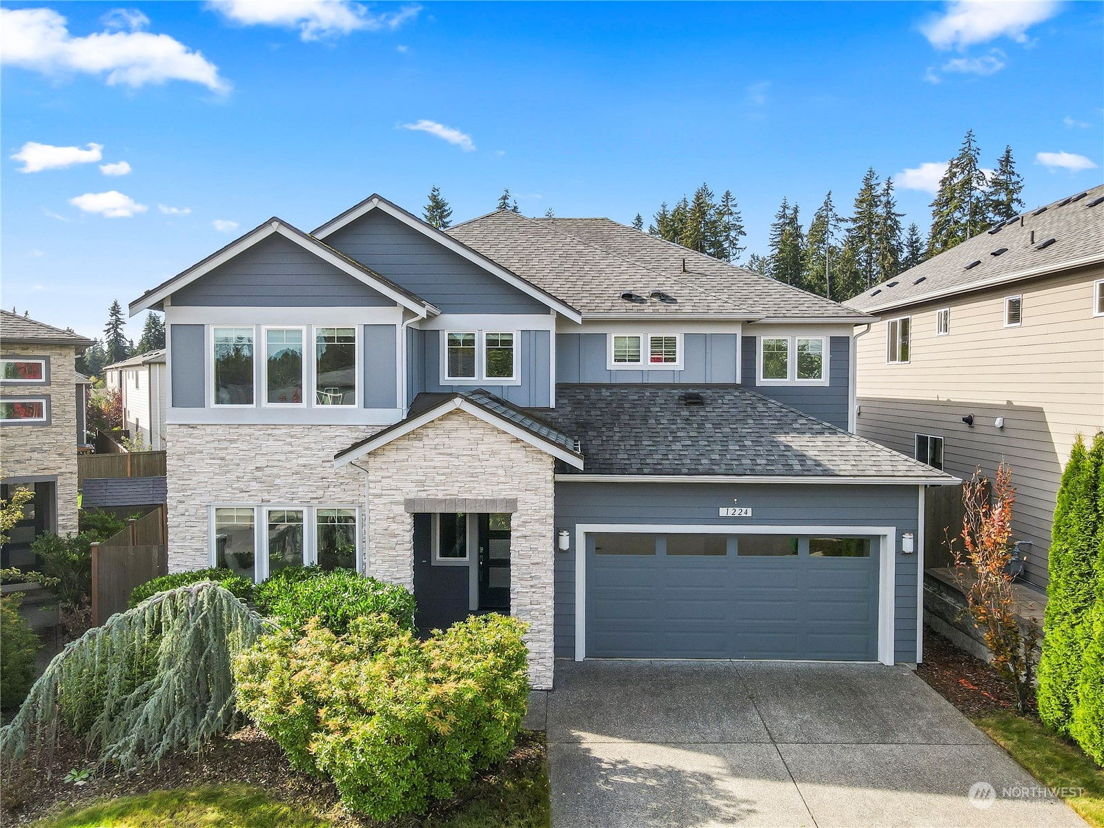 1224 198th Place Southeast Bothell, WA 98012 - Photo 1 of 38 a front view of a house with a garden and plants
