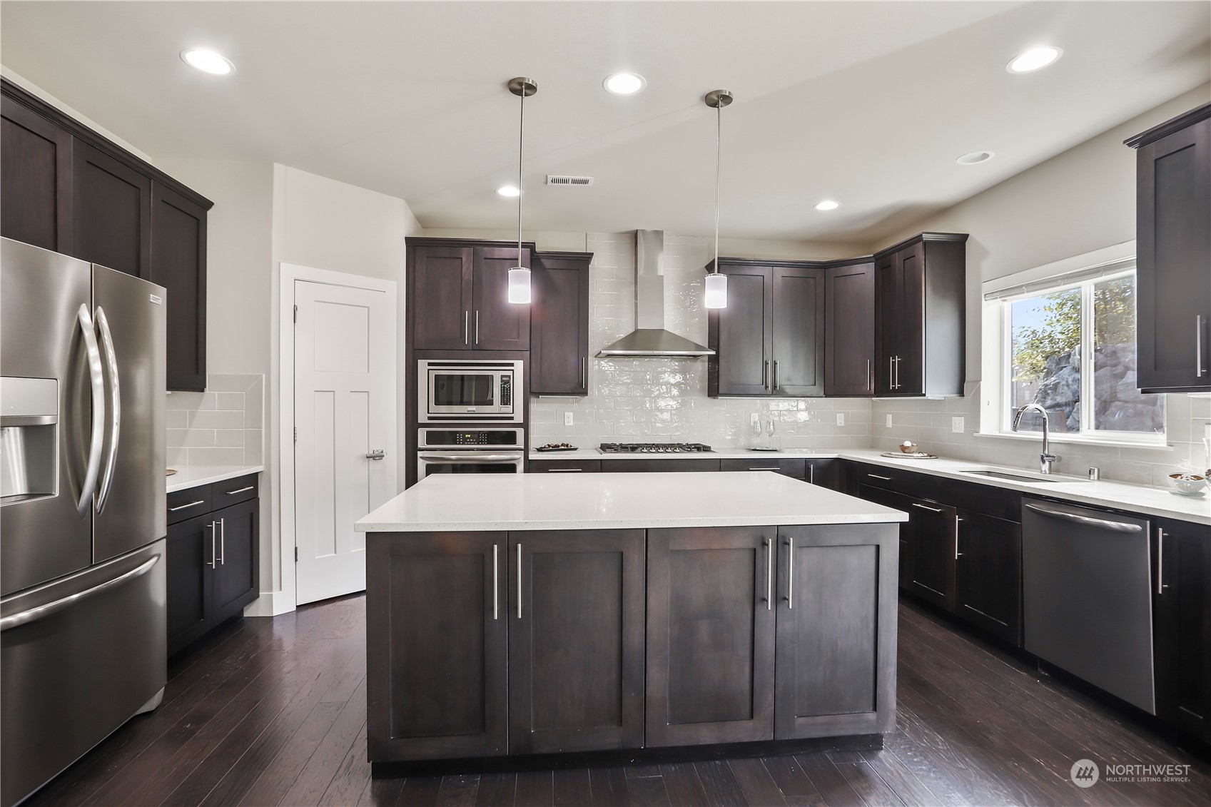 1224 198th Place Southeast Bothell, WA 98012 - Photo 11 of 38 a large kitchen with kitchen island a sink stainless steel appliances and cabinets
