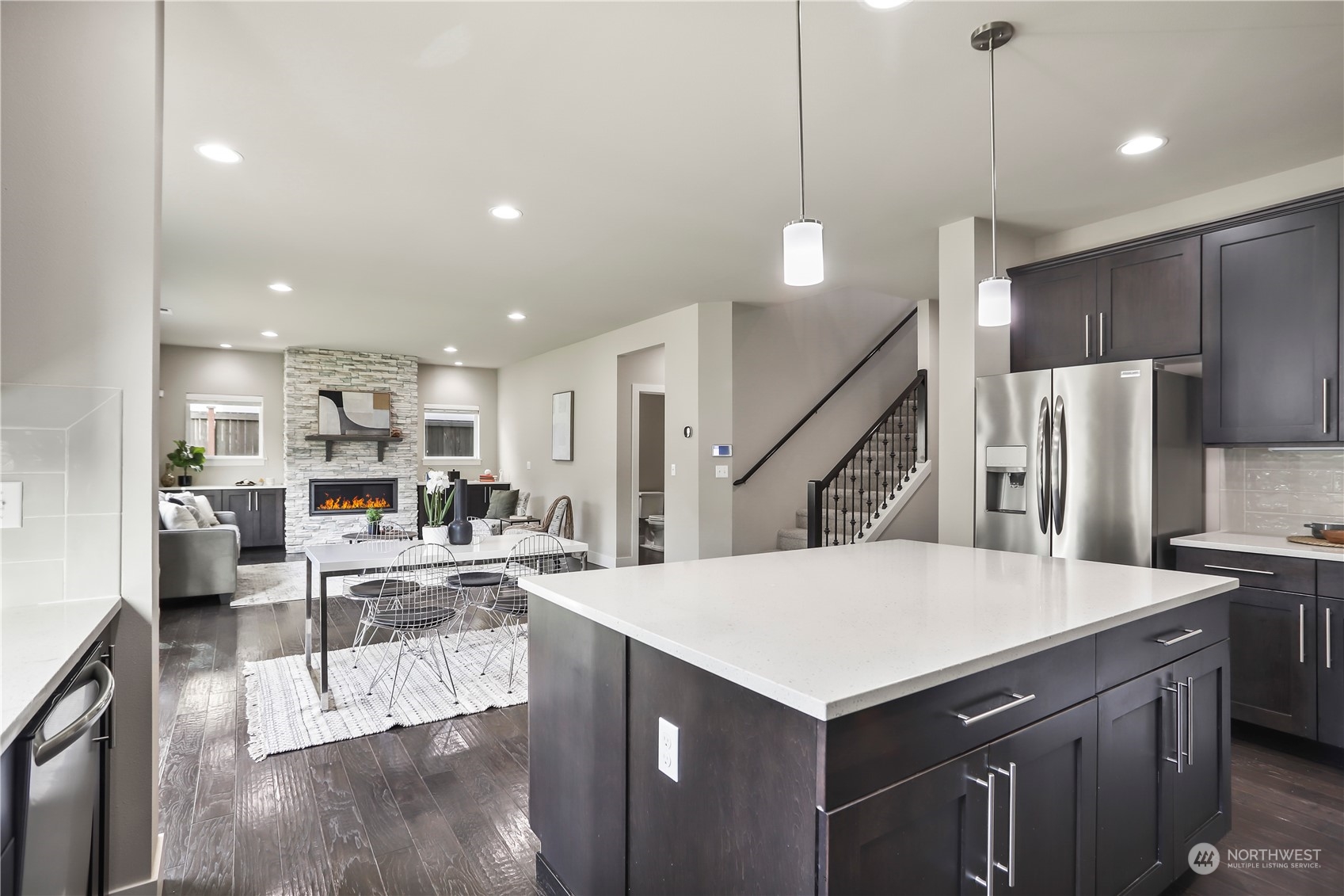 1224 198th Place Southeast Bothell, WA 98012 - Photo 12 of 38 a kitchen with stainless steel appliances kitchen island granite countertop a refrigerator a stove and a sink with wooden floor