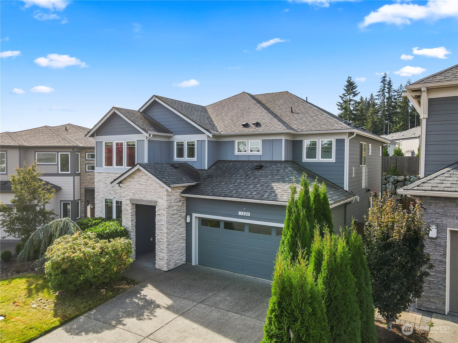 1224 198th Place Southeast Bothell, WA 98012 - Photo 2 of 38 a front view of a house with a garden