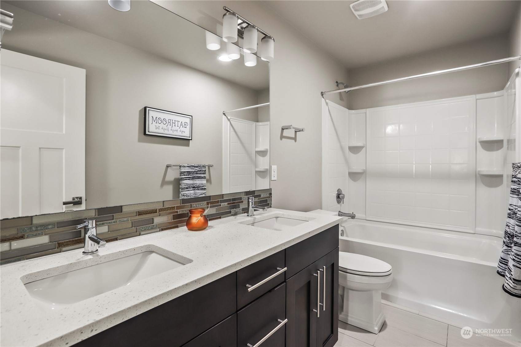 1224 198th Place Southeast Bothell, WA 98012 - Photo 26 of 38 a bathroom with a sink a toilet a mirror and shower